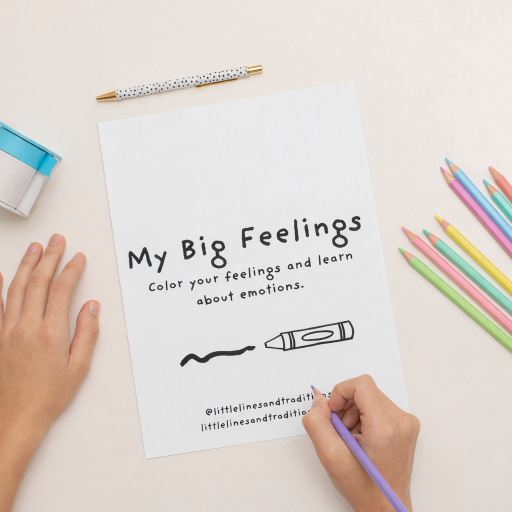 Coloring book titled 'My Big Feelings' with colored pencils on a light surface